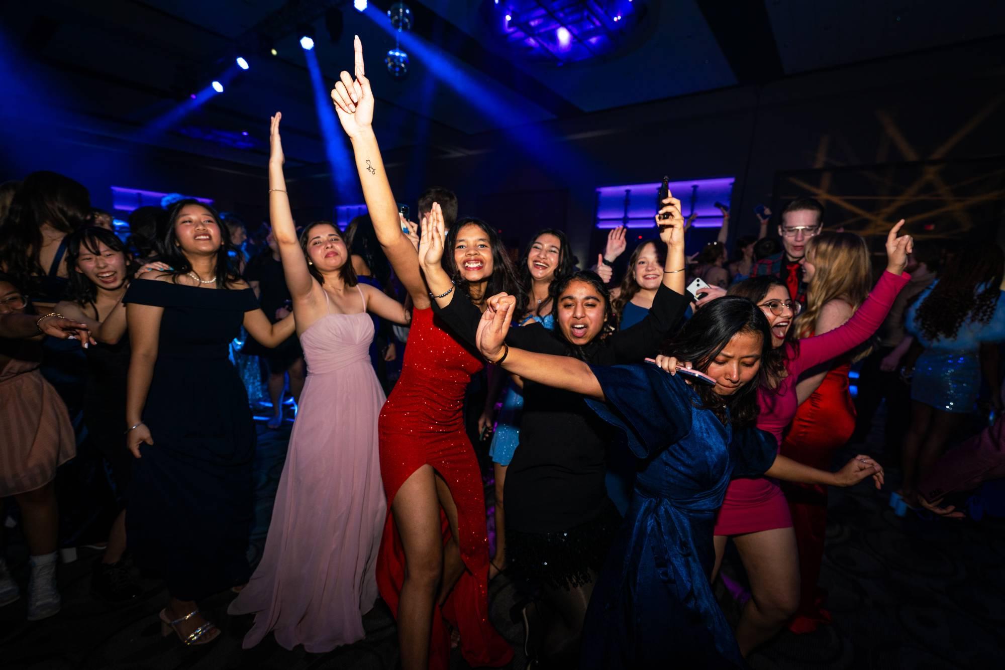 Students smiling and dancing at Presidents' Ball